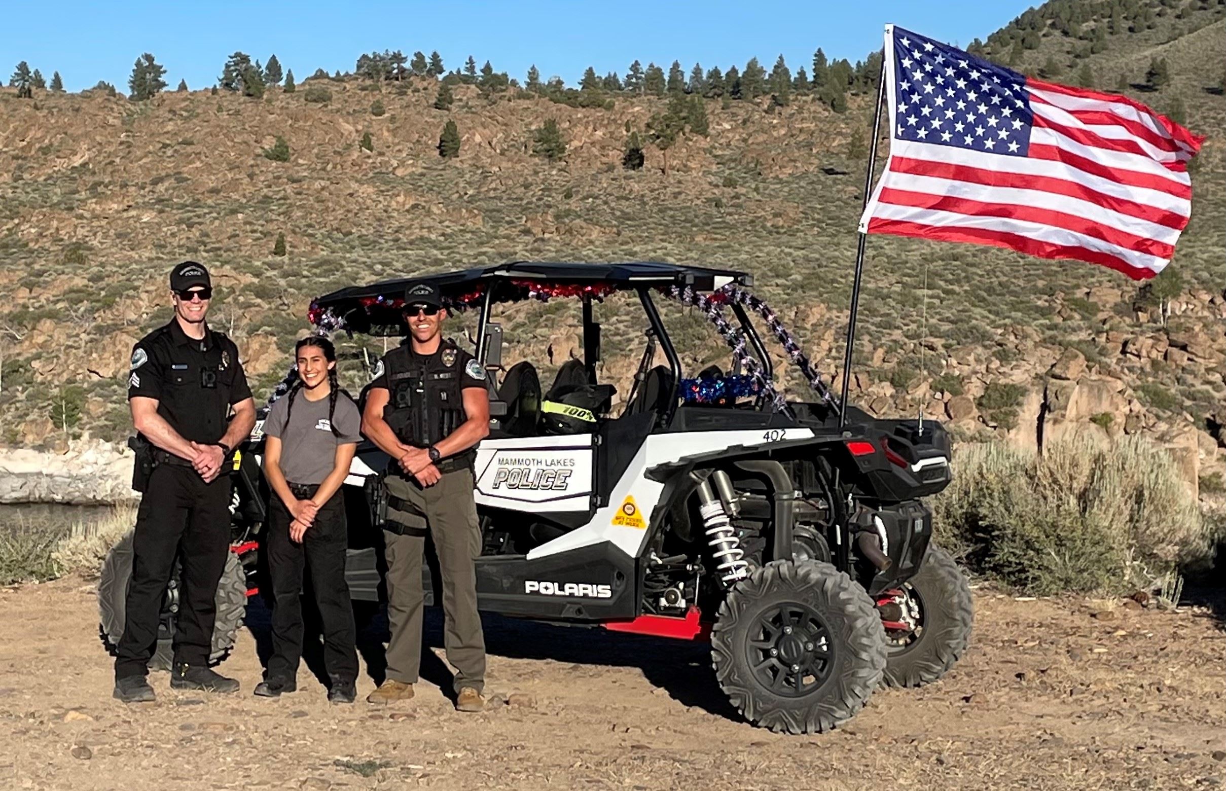 3 Officers smiling and standing in front of Polaris RZR